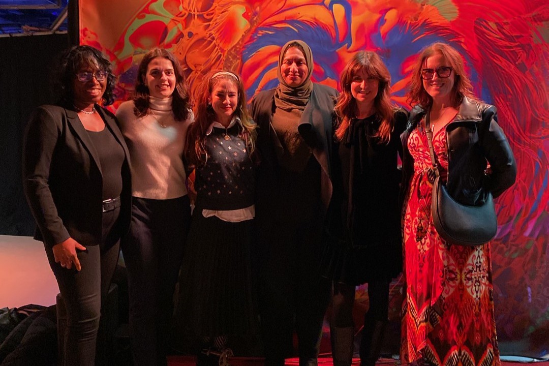 From left to right, a group photo of Trustee Deborah Williams, Julia Celage from Humberside CI, Beckie DiLeo from Central Toronto Academy, Deputy Mayor Ausma Malik, Director Karen Francis, and Ursula McDonnell from Lawrence Park CI. They are standing in front of one of the artworks at the exhibition.