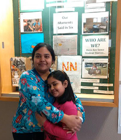 Parent Naghma hugging her daughter at the school while she volunteers in the building