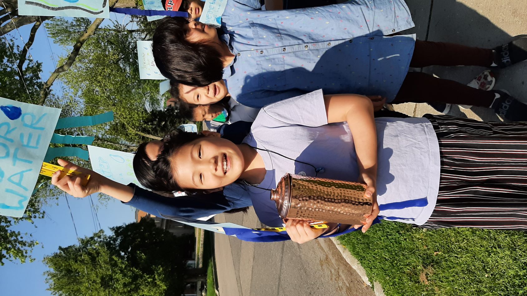 Hollywood PS student carrying water in a copper pot during the Water Walk.