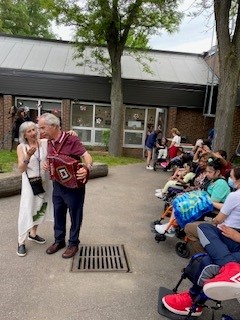 Author Bruna DiGiuseppe Bertoni and accordion-player Enzo Di Palma decide on which song to play for the students.