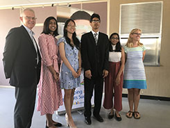 TDSB Top Scholar students posing with Director of Education, John Malloy and Chair of the Board, Robin Pilkey in hallway.