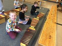 Elementary students participating in a music lesson