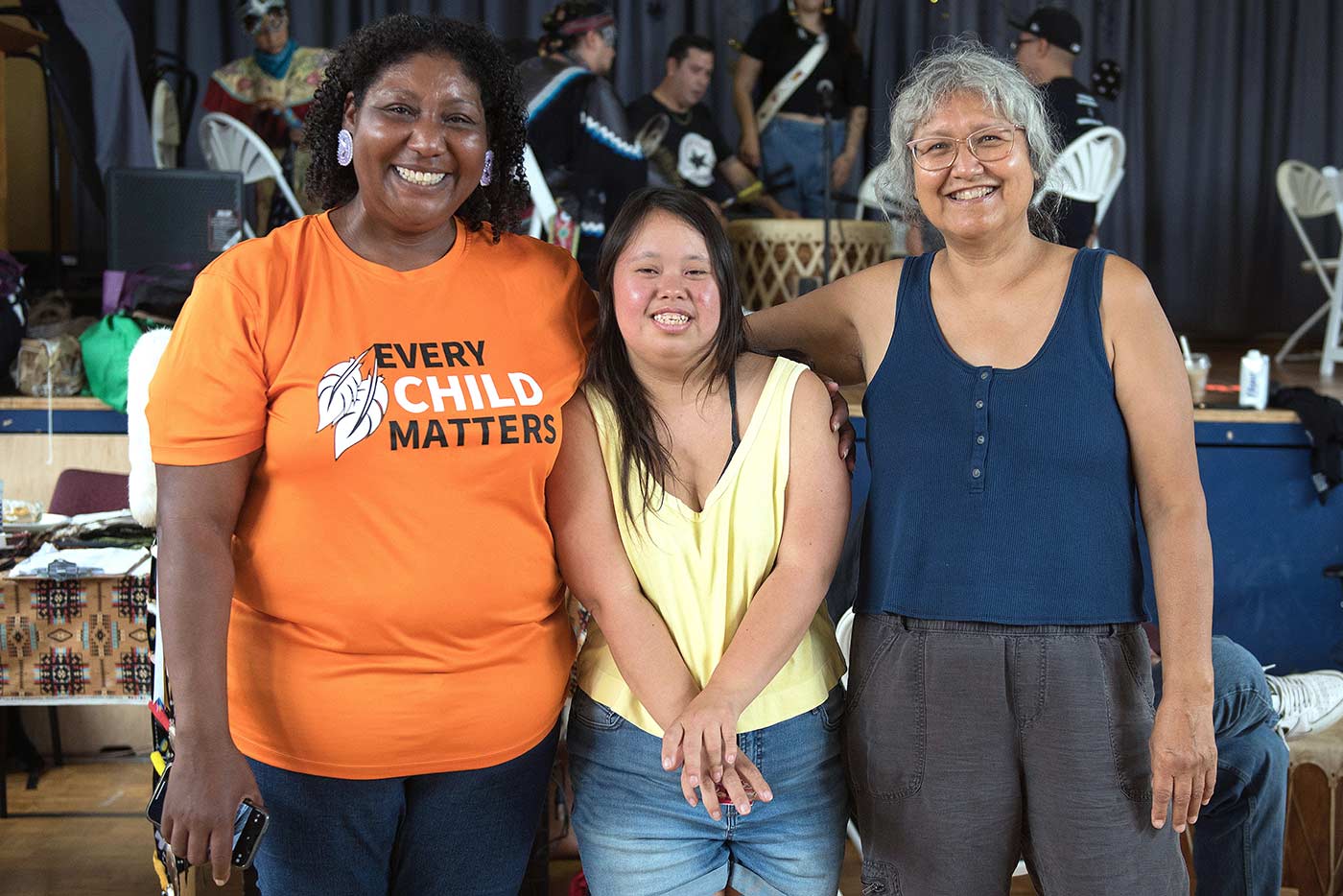 Two educators and a student pose for a photo, smiling 