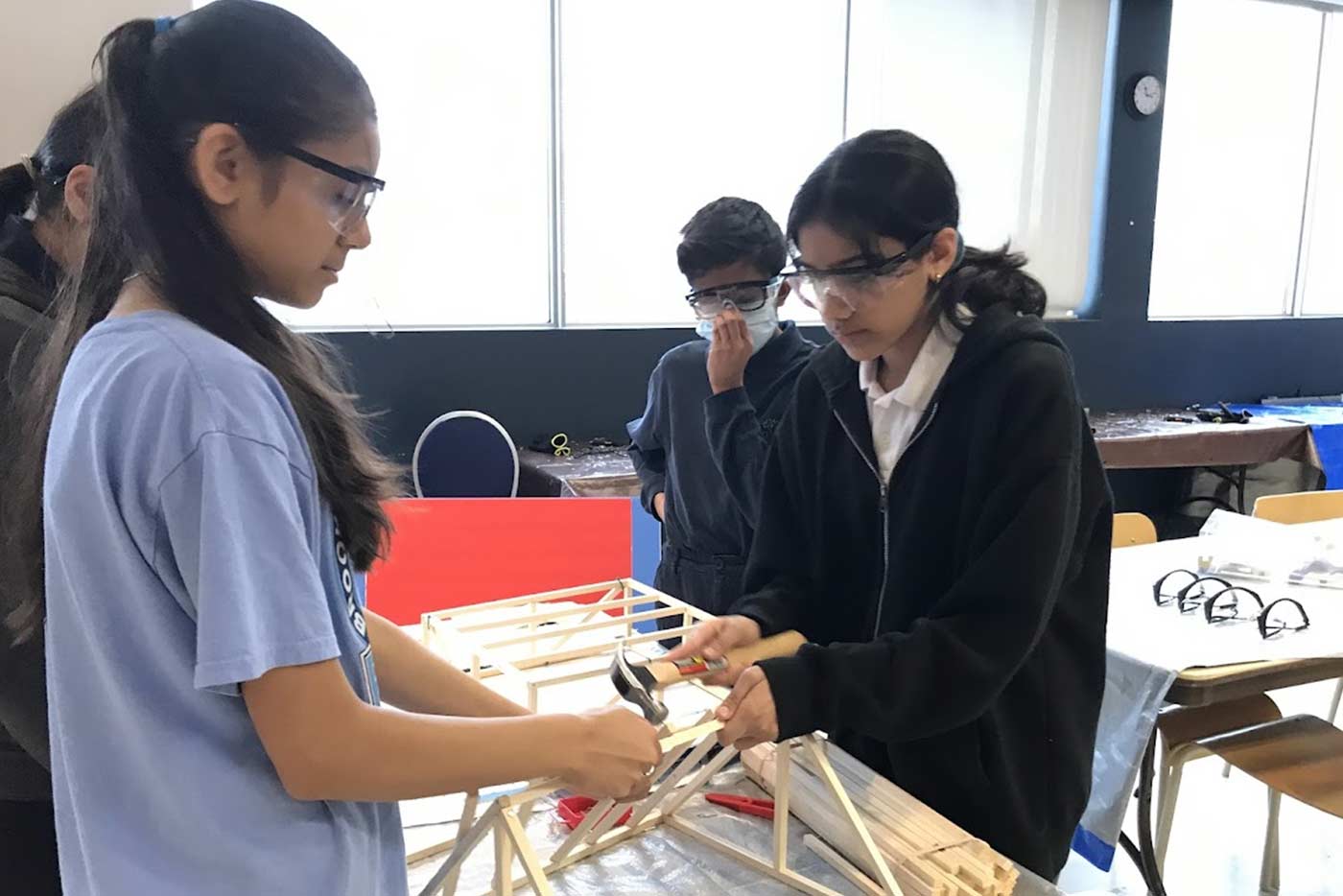 Students constructing wooden model