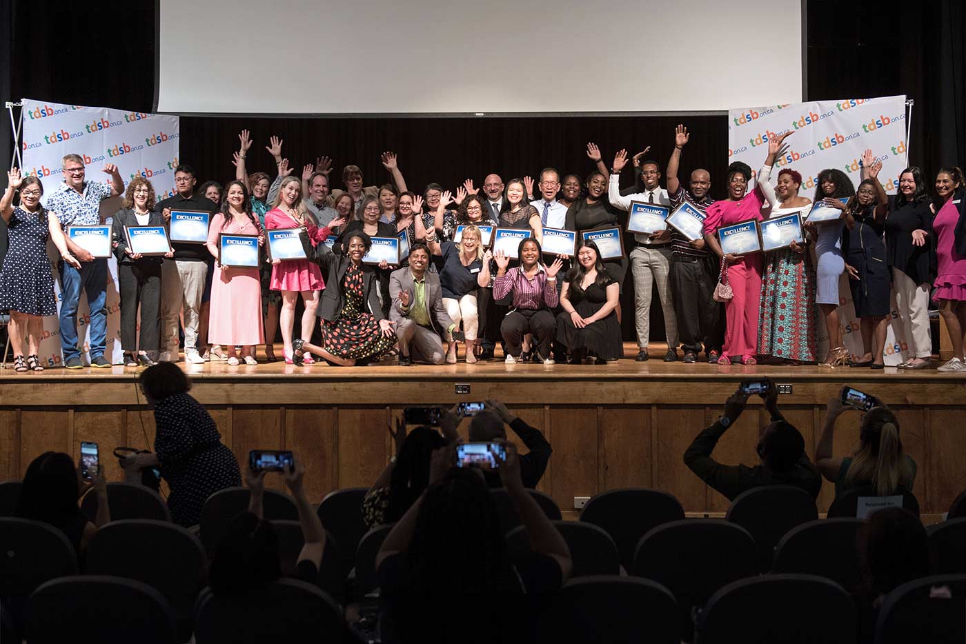 Large group of staff on a stage